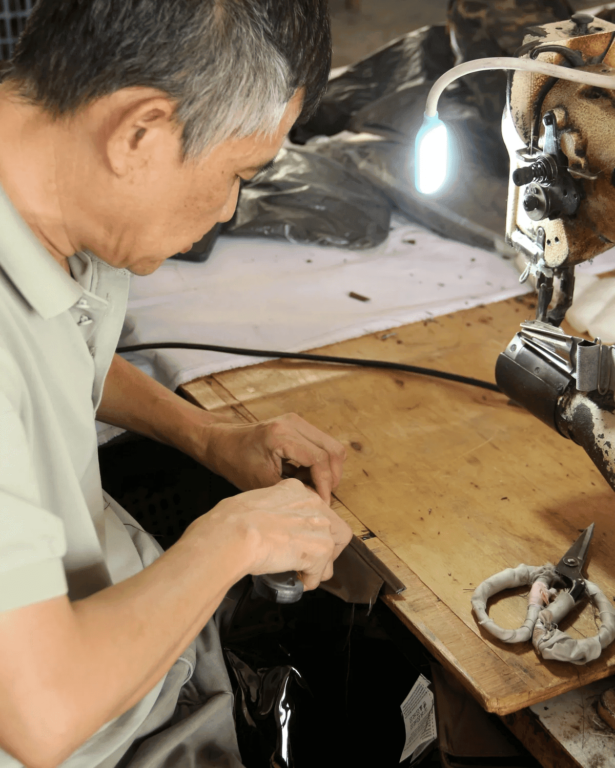 Sample maker operating a sewing machine in the workshop
