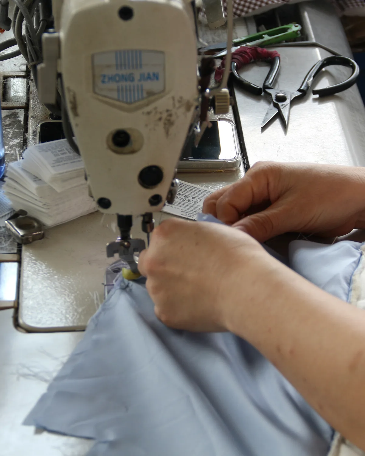 Prototype sample being sewn at an industrial machine