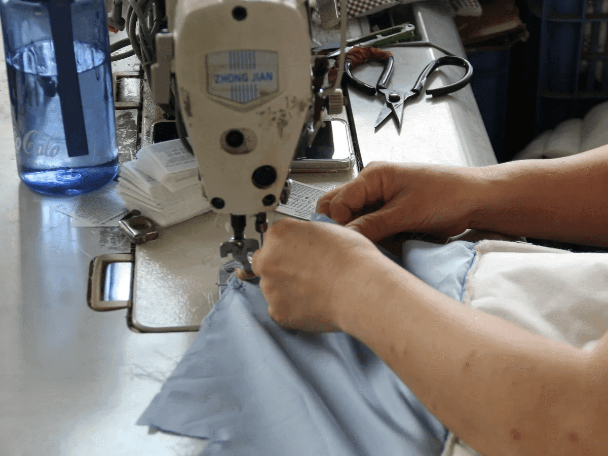 Close-up OEM bag sewing work for a technical commuter bag program